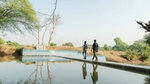 Two men at a water reservoir.