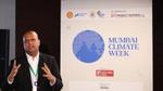 Person speaking at Mumbai Climate Week event.