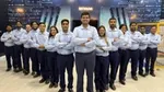 14 employees from Unilever’s Tinsukia Beauty & Wellbeing factory in India, a WEF Lighthouse Network site. They are wearing light blue shirts, standing and smiling at the camera.