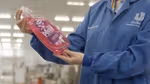 Unilever scientist inspecting Wonder Wash bottle made from recycled plastic