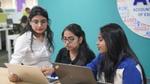 A group of women employees working on their laptops